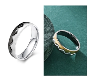 Macro detail of mountain jagged rings in silver-black and gold-silver with stone inlay