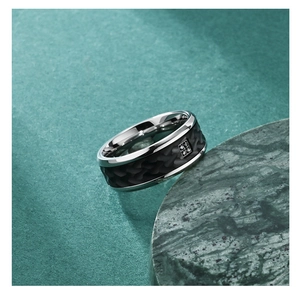 Macro detail of men's titanium ring with tree bark texture and four inlaid cubic zirconia stones
