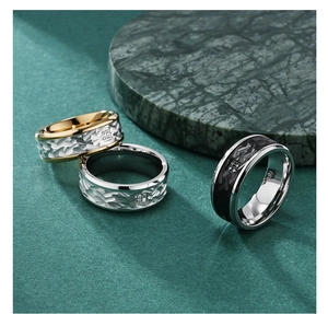 Detailed close-up of men's rings featuring bark texture and square stone settings