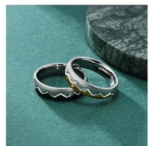 Macro shot of mountain pattern rings with brushed finish and inlaid stones
