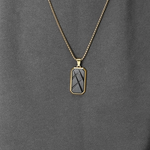 Men's octagonal gold pendant necklace with black textured carbon fiber inlay on box chain