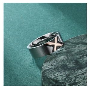 Detail of brushed titanium steel ring with rose gold X-pattern and polished inner surface