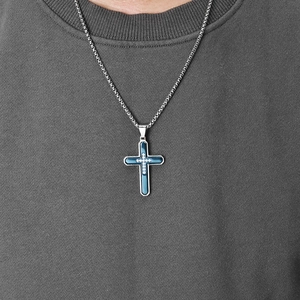 Men's silver and blue steel cross necklace with stones on grey knit sweater