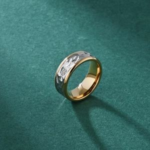 Men's titanium steel ring with bark texture surface and inlaid stones on green background