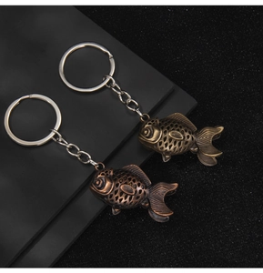Detail of vintage koi fish keychains in bronze and copper finishes with intricate scales
