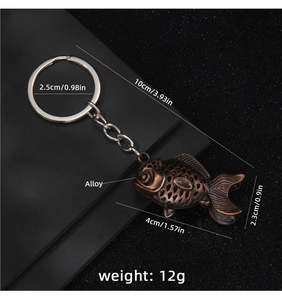 Close-up of vintage bronze fish keychain with detailed scales and hollow alloy design