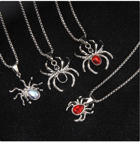 Detail view of gothic spider pendants featuring colorful rhinestones on stainless steel chains