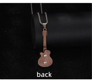 Detailed back view of vintage bronze guitar pendant with silver bead chain necklace