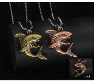 Detailed macro view of vintage shark pendant necklace with realistic carving and crystal back