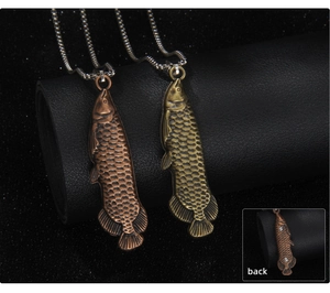 Detail view showing fish pendant necklace with intricate scale texture in bronze metal