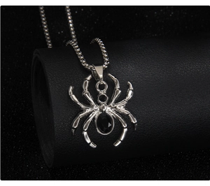 Detailed view of punk spider pendant with black rhinestones on a silver box chain