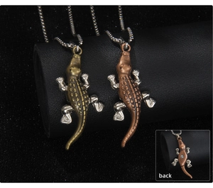Detailed view of crocodile animal pendants in bronze and copper tones with bead chains