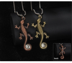 Close-up of vintage lizard pendant with textured scales and round zircon stone inlay