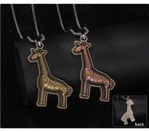 Detail of vintage giraffe pendant necklaces in antique gold and bronze finish
