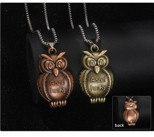 Macro detail of retro owl pendant with magnetic back and Good Lucky engraving
