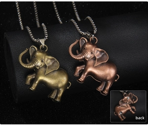 Detailed back view of vintage elephant pendants showing the embedded magnets on metal