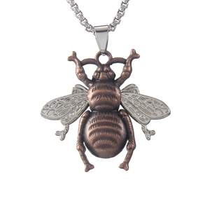 Vintage bronze and silver bee pendant necklace with detailed insect wings on white background