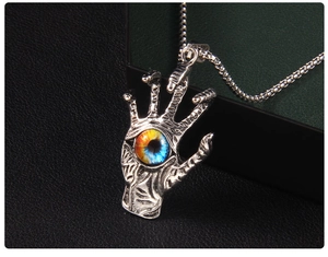 Detailed close-up of Gothic silver hand pendant with blue eye and stainless steel bead chain