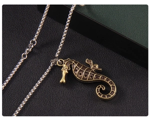 Detailed view of vintage seahorse pendant with bronze finish and stainless steel chain