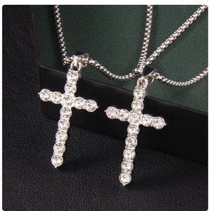 Close-up of hip hop silver plated cross necklaces with sparkling cubic zirconia pavé