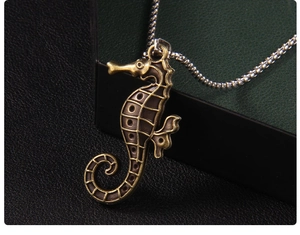 Detailed close-up of retro seahorse pendant with antique metallic finish and bead chain