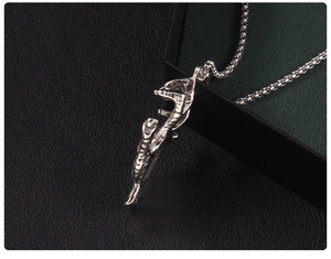 Detailed close-up of a realistic silver scorpion pendant with a fine box chain necklace