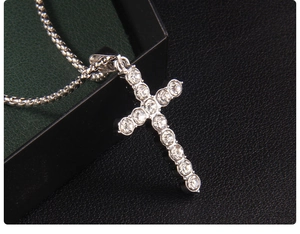 Close-up of a silver hip-hop cross necklace with round rhinestones on a box chain