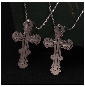 Macro view of vintage layered silver cross pendants with polished stainless steel bead chains