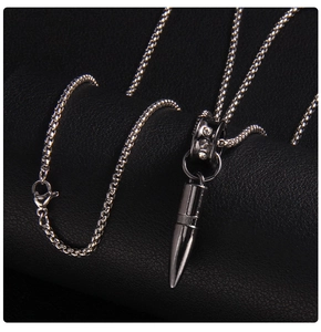 Macro detail of industrial bullet pendant necklace with crystals on box chain