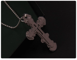 Detail view of triple-layered silver steel cross pendant with a multi-tiered metal design