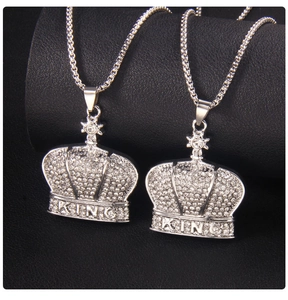 Close-up of crown pendants with King engraving and pavé set rhinestones on box chains