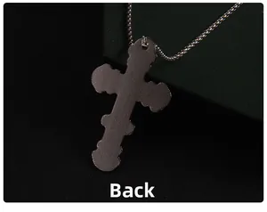 Detailed back view of large black cross pendant with textured mesh pattern on steel