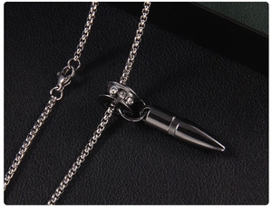 Macro shot of black bullet pendant necklace with crystal ring on box chain clasp