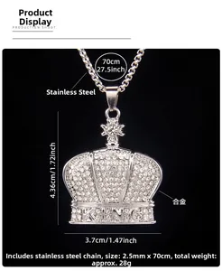 Macro detail of iced-out crown pendant with KING engraving and stainless steel chain