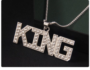 Close-up of KING letter pendant necklace with sparkling white rhinestones on twisted chain