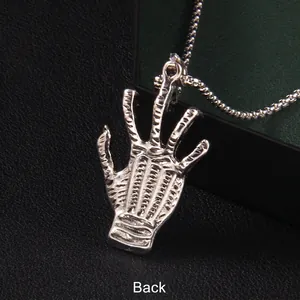 Silver stainless steel Hamsa hand pendant back view on black textured surface
