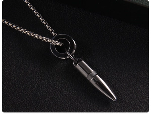Close-up of black stainless steel bullet pendant with circular ring on round link chain