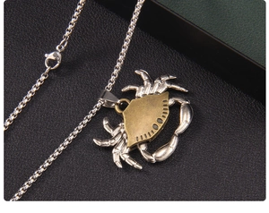 Detailed shot of retro crab pendant with bronze shell and silver limbs on a metal chain