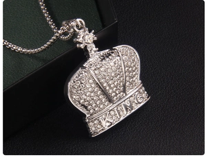 Close-up of hip hop silver crown pendant with rhinestones and KING engraving
