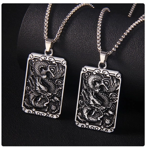 Detailed view of square dragon relief pendant in stainless steel with box chain