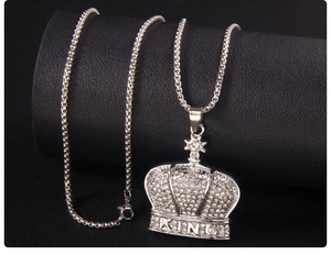 Detail of silver crown pendant with cubic zirconia inlay and KING lettering on box chain