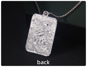 Detailed back view of a silver square dragon pendant with intricate relief carvings