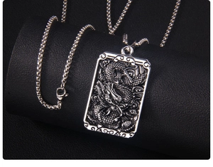 Detailed relief of a dragon pendant on a square stainless steel vintage necklace
