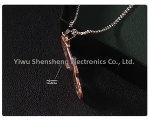 Macro detail of vintage motorcycle pendant featuring movable handlebars on snake chain