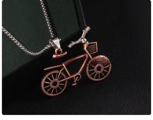 Macro detail of vintage bronze bicycle pendant with intricate spokes on silver chain
