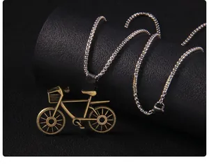 Macro detail of retro bronze bicycle pendant on a silver stainless steel box chain