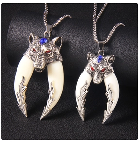 Detail of gothic wolf head pendants with red and blue rhinestones on bead chains