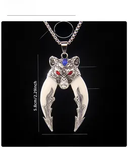 Detail of vintage double wolf fang necklace with red rhinestone eyes and acrylic tusks