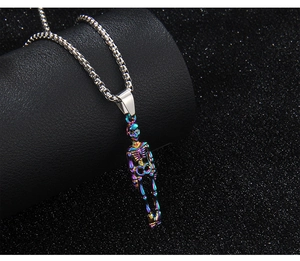 Detailed macro view of hip hop skull pendant with rainbow iridescent finish on box chain