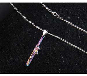 Macro shot of stainless steel sword pendant with rainbow plating and dragon relief